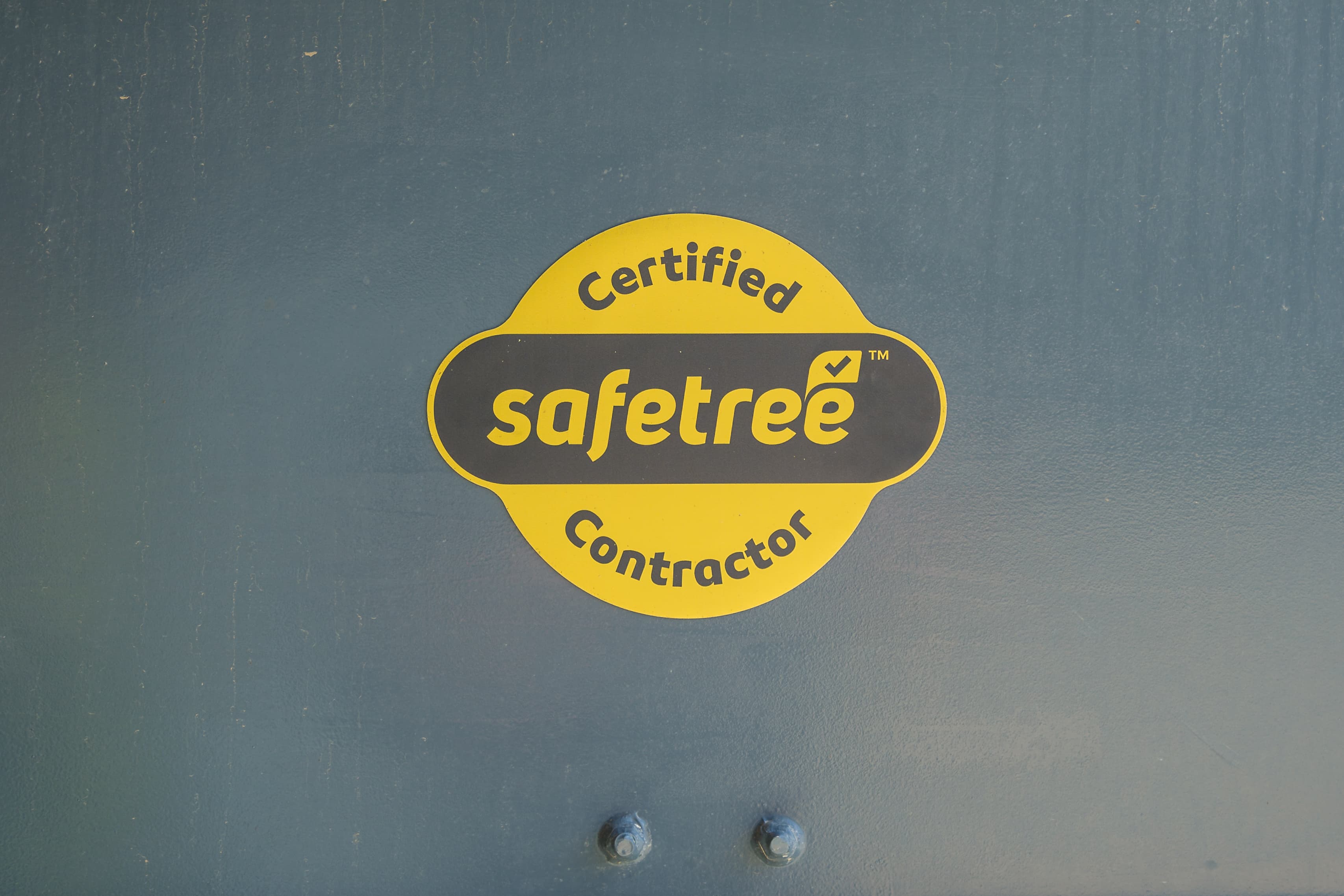 certified safetree contractor logo on metal background.